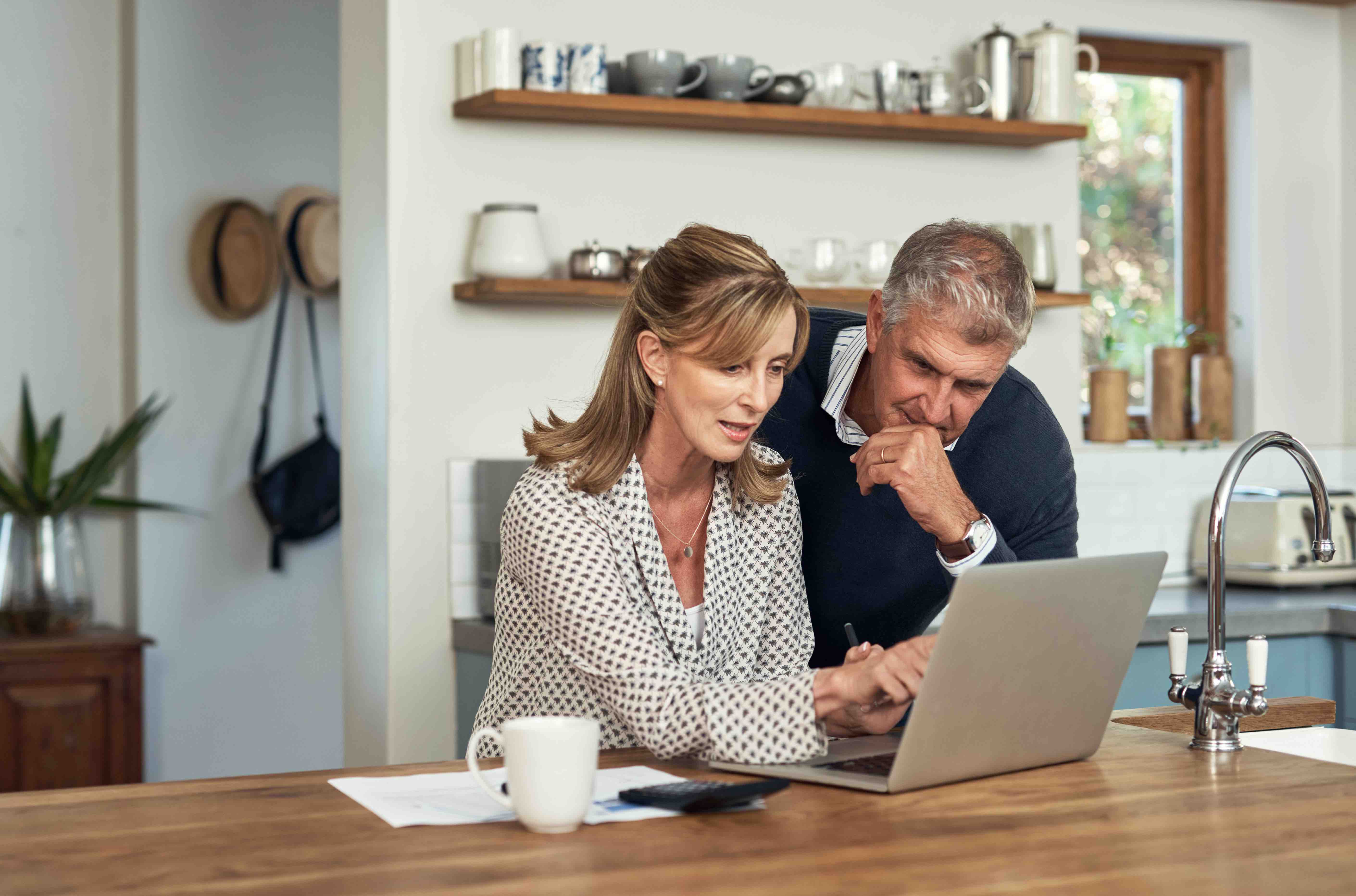 couple looking at insurance on laptop